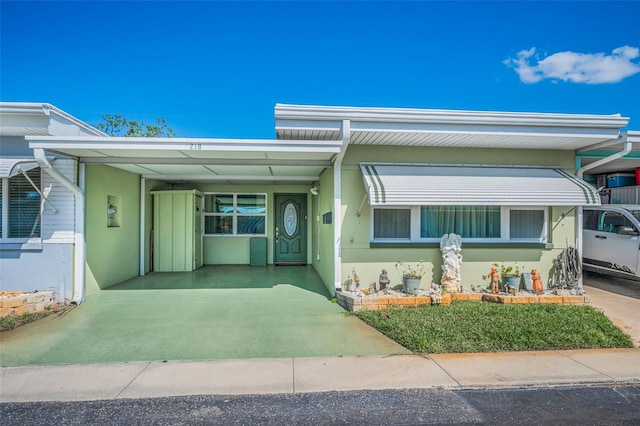 250 Rosery Rd NW Unit 218, Largo, FL 33770 - view of front of house with a carport and stucco siding