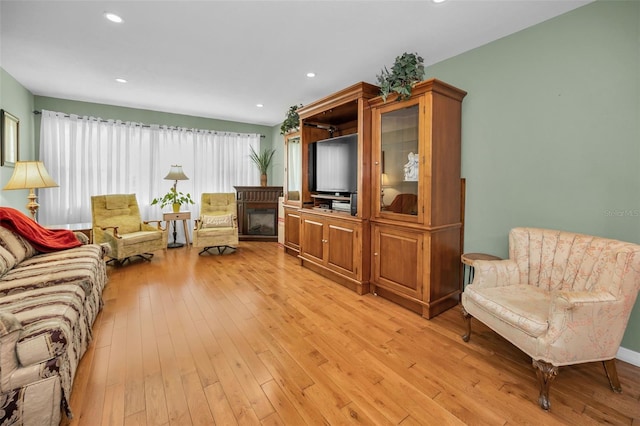 250 Rosery Rd NW Unit 218, Largo, FL 33770 - living area featuring light wood-type flooring, a glass covered fireplace, and recessed lighting