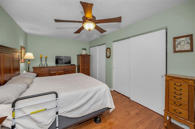 250 Rosery Rd NW Unit 218, Largo, FL 33770 - bedroom with multiple closets, wood finished floors, and ceiling fan