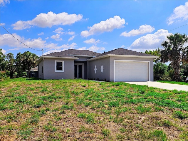 3115 52nd St W, Lehigh Acres, FL 33971 - view of front of property with french doors, an attached garage, stucco siding, driveway, and a front yard