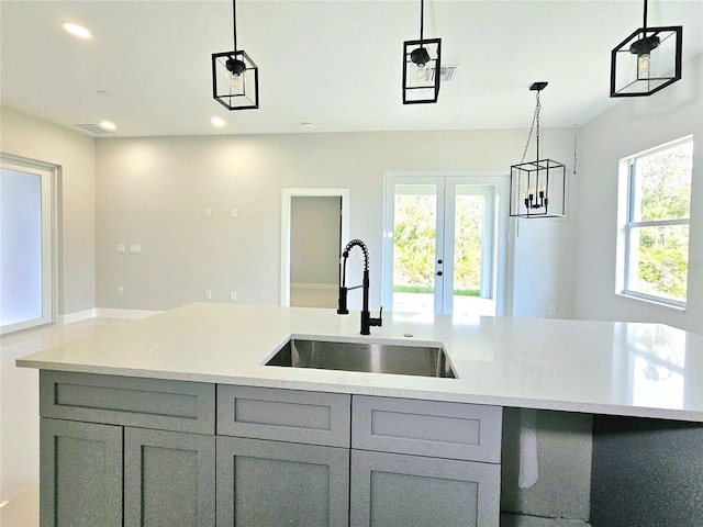 3115 52nd St W, Lehigh Acres, FL 33971 - kitchen featuring gray cabinetry, a sink, french doors, recessed lighting, and light stone counters