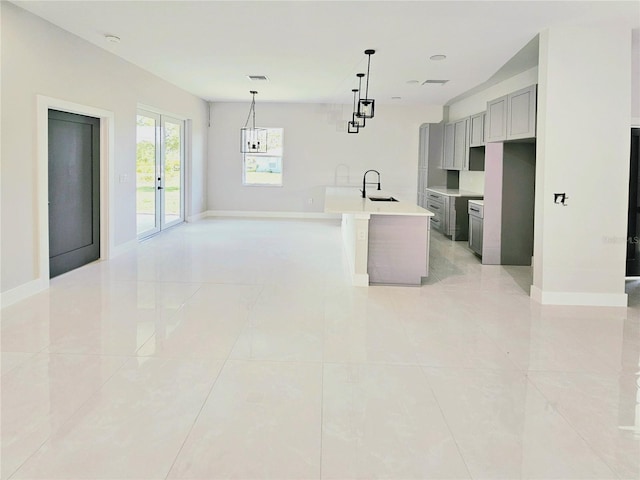 3115 52nd St W, Lehigh Acres, FL 33971 - kitchen with a sink, gray cabinets, light countertops, and baseboards