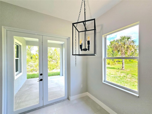 3115 52nd St W, Lehigh Acres, FL 33971 - entryway with french doors, baseboards, and light tile patterned flooring