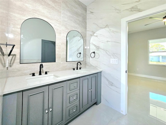 3115 52nd St W, Lehigh Acres, FL 33971 - full bath featuring tile walls, double vanity, and tile patterned floors