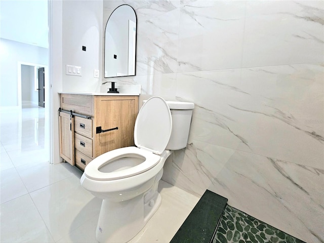 3115 52nd St W, Lehigh Acres, FL 33971 - bathroom featuring toilet, vanity, tile patterned floors, and tile walls
