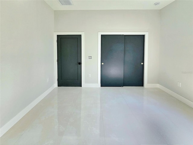 3115 52nd St W, Lehigh Acres, FL 33971 - unfurnished bedroom featuring baseboards, a closet, and tile patterned floors