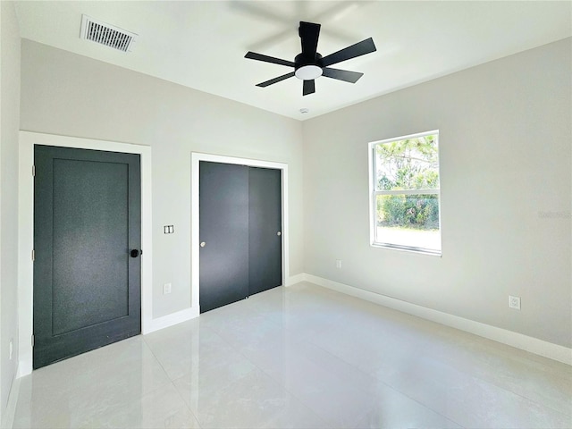 3115 52nd St W, Lehigh Acres, FL 33971 - unfurnished bedroom featuring baseboards, light tile patterned flooring, and ceiling fan