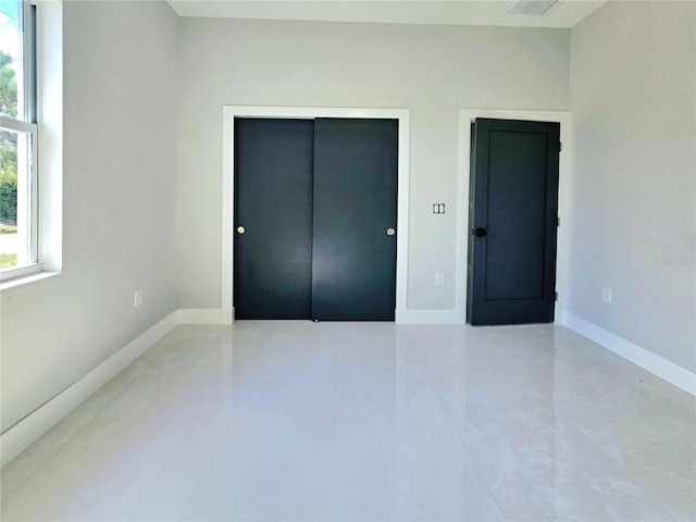 3115 52nd St W, Lehigh Acres, FL 33971 - unfurnished bedroom with baseboards, a closet, and tile patterned floors