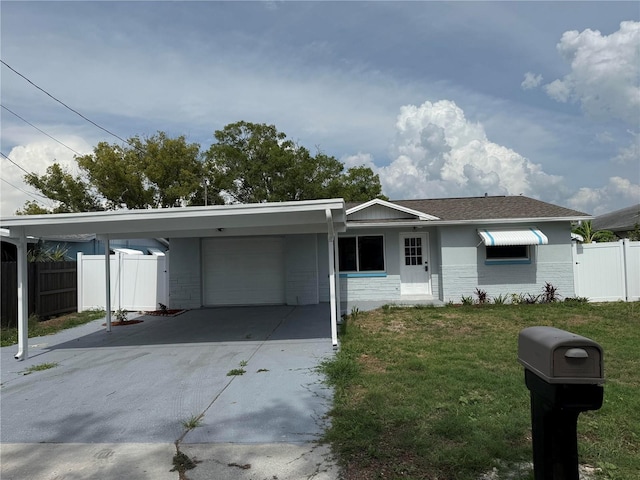 13314 Lisa Dr, Hudson, FL 34667 - view of front of house with an attached garage, an attached carport, stucco siding, and driveway