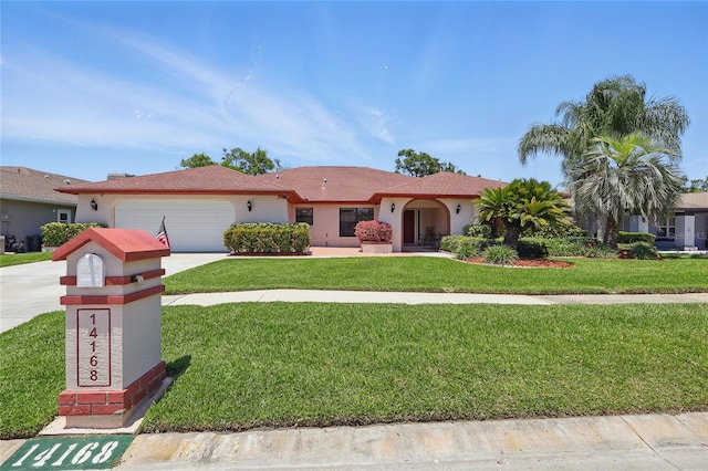 14168 Fennsbury Dr, Tampa, FL 33624 - ranch-style house featuring a garage, a front lawn, concrete driveway, and stucco siding