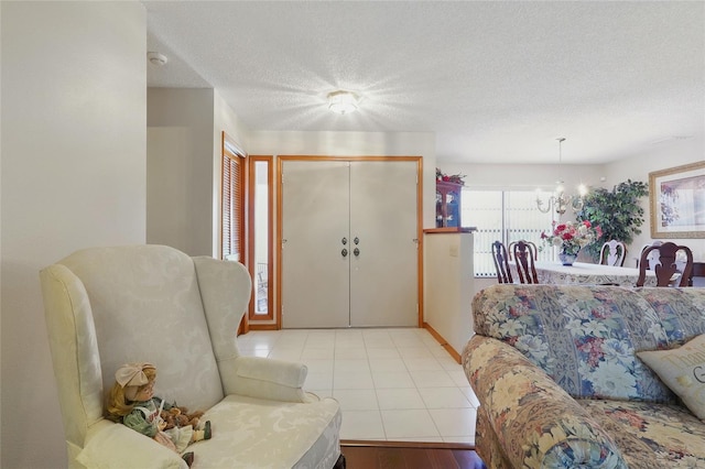 14168 Fennsbury Dr, Tampa, FL 33624 - tiled living area with a textured ceiling and a chandelier