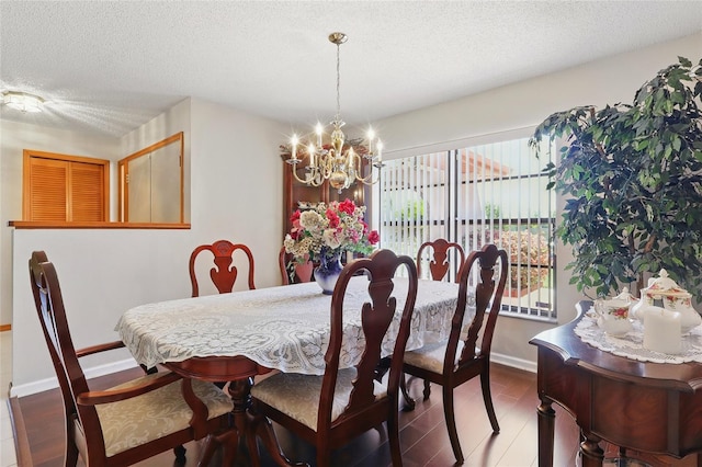 14168 Fennsbury Dr, Tampa, FL 33624 - dining area with a chandelier, a textured ceiling, wood finished floors, and baseboards