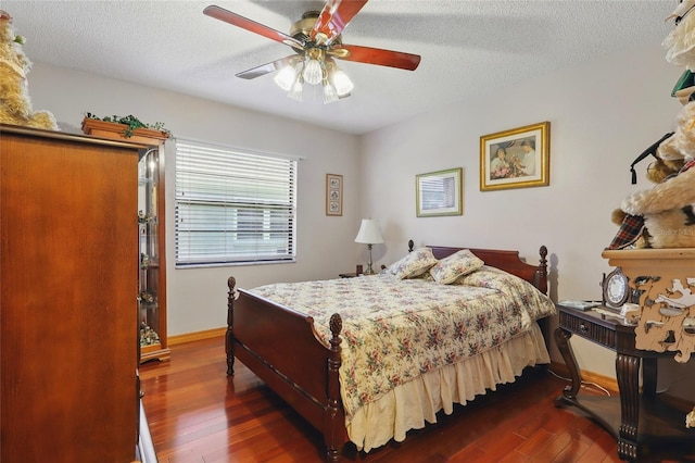 14168 Fennsbury Dr, Tampa, FL 33624 - bedroom featuring dark wood-style flooring, a textured ceiling, ceiling fan, and baseboards