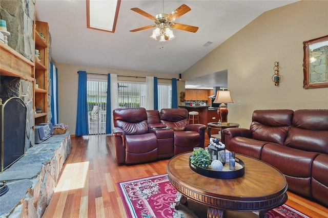14168 Fennsbury Dr, Tampa, FL 33624 - living area featuring lofted ceiling, a fireplace, a ceiling fan, and wood finished floors
