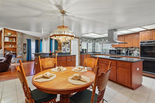 14168 Fennsbury Dr, Tampa, FL 33624 - dining room with light tile patterned floors, a chandelier, and vaulted ceiling