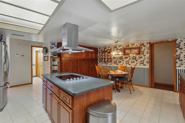 14168 Fennsbury Dr, Tampa, FL 33624 - kitchen featuring island exhaust hood, freestanding refrigerator, electric stovetop, dark countertops, and wallpapered walls