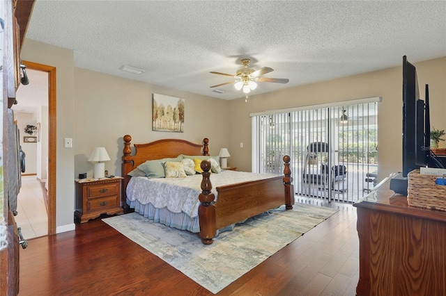 14168 Fennsbury Dr, Tampa, FL 33624 - bedroom featuring access to outside, dark wood-style flooring, a textured ceiling, and ceiling fan