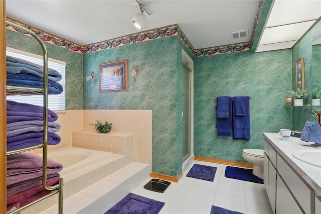 14168 Fennsbury Dr, Tampa, FL 33624 - full bathroom featuring tile patterned flooring, vanity, toilet, a bath, and a stall shower