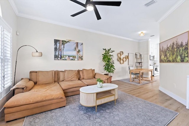 230 Columbia Dr, Tampa, FL 33606 - living room with light wood-style floors, a ceiling fan, ornamental molding, and baseboards