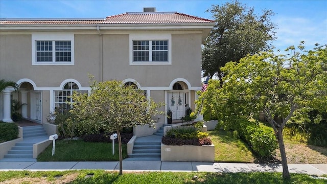 230 Columbia Dr, Tampa, FL 33606 - view of front facade with a tile roof, stucco siding, stairway, and french doors