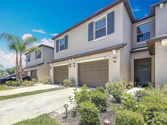 841 Royal Empress Dr, Ruskin, FL 33570 - townhome / multi-family property with an attached garage, driveway, and stucco siding