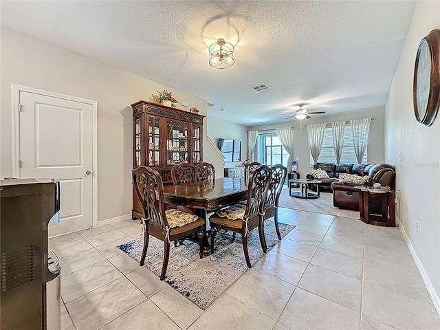 841 Royal Empress Dr, Ruskin, FL 33570 - dining room featuring a ceiling fan, a textured ceiling, light tile patterned flooring, and baseboards