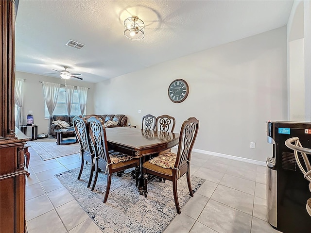 841 Royal Empress Dr, Ruskin, FL 33570 - dining space featuring light tile patterned floors, ceiling fan, baseboards, and a textured ceiling