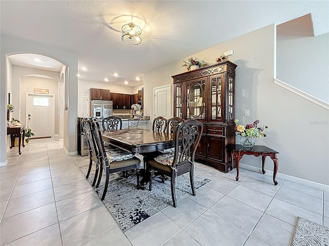 841 Royal Empress Dr, Ruskin, FL 33570 - dining area with arched walkways, light tile patterned flooring, and baseboards