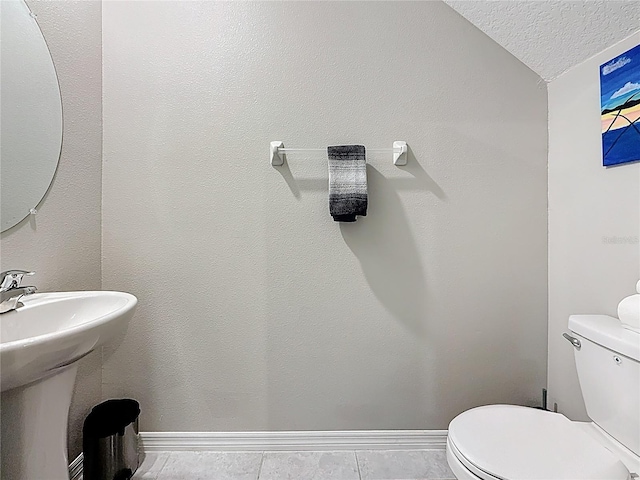 841 Royal Empress Dr, Ruskin, FL 33570 - half bath with toilet, a textured ceiling, baseboards, a sink, and tile patterned flooring