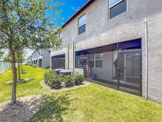 841 Royal Empress Dr, Ruskin, FL 33570 - rear view of property with stucco siding and central AC unit