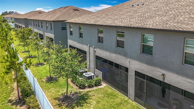 841 Royal Empress Dr, Ruskin, FL 33570 - view of home's exterior with a shingled roof, central AC unit, and stucco siding