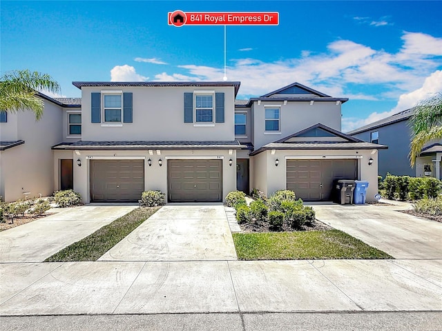 841 Royal Empress Dr, Ruskin, FL 33570 - view of front facade with stucco siding, driveway, and a garage