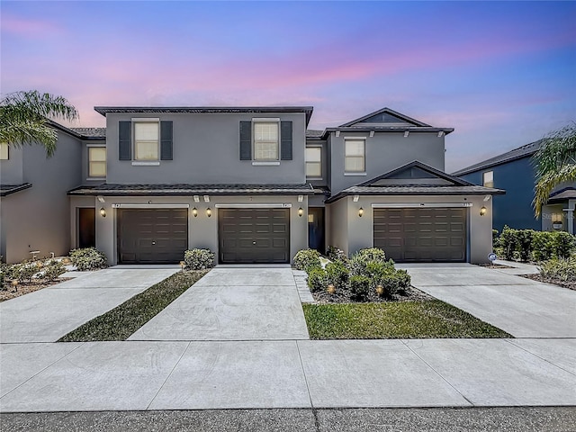 841 Royal Empress Dr, Ruskin, FL 33570 - view of front of house featuring stucco siding, driveway, and an attached garage