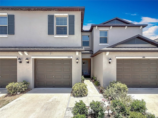 841 Royal Empress Dr, Ruskin, FL 33570 - view of front of home with stucco siding, a garage, and concrete driveway