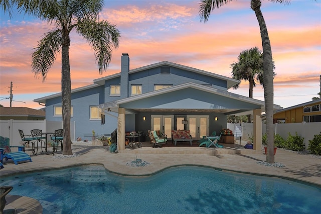 931 Gulf Blvd, Belleair Beach, FL 33786 - rear view of property with stucco siding, french doors, a patio area, a chimney, and outdoor lounge area