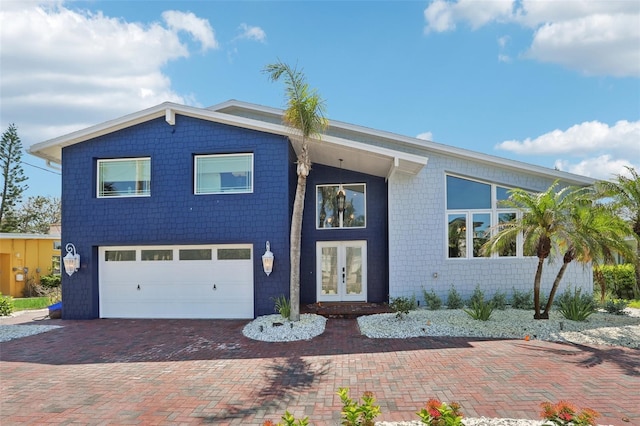 931 Gulf Blvd, Belleair Beach, FL 33786 - view of front facade featuring french doors, a garage, and decorative driveway