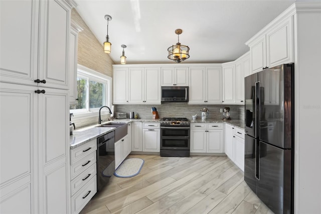 931 Gulf Blvd, Belleair Beach, FL 33786 - kitchen with black appliances, a sink, decorative backsplash, light stone counters, and white cabinetry