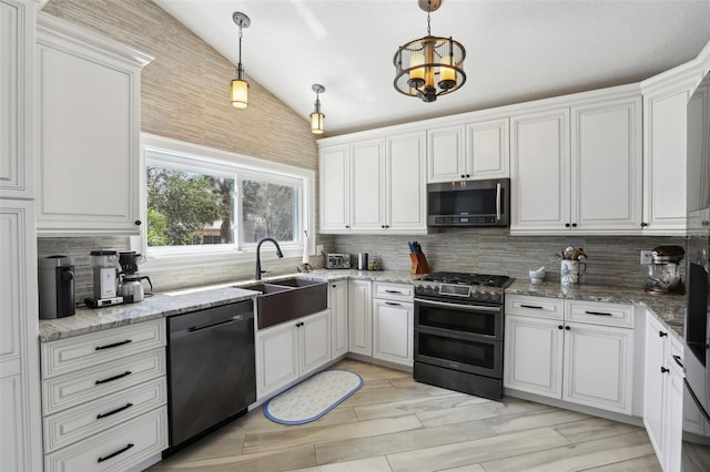 931 Gulf Blvd, Belleair Beach, FL 33786 - kitchen featuring stainless steel appliances, a sink, lofted ceiling, white cabinetry, and decorative backsplash
