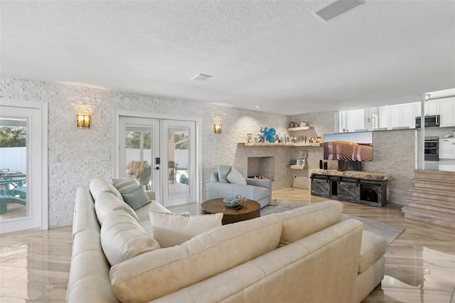 931 Gulf Blvd, Belleair Beach, FL 33786 - living area featuring healthy amount of natural light, french doors, and a textured ceiling