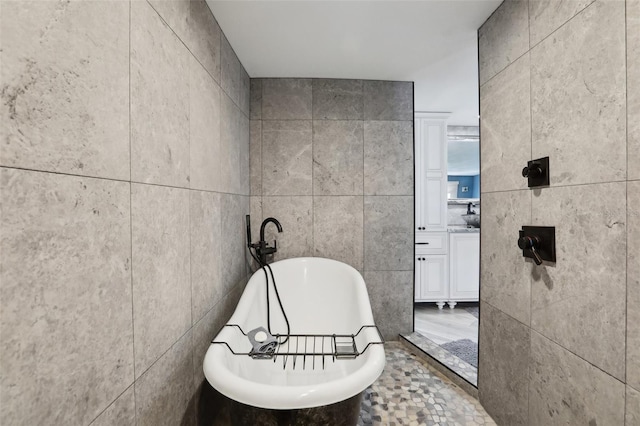 931 Gulf Blvd, Belleair Beach, FL 33786 - bathroom with tile walls, a freestanding bath, and vanity