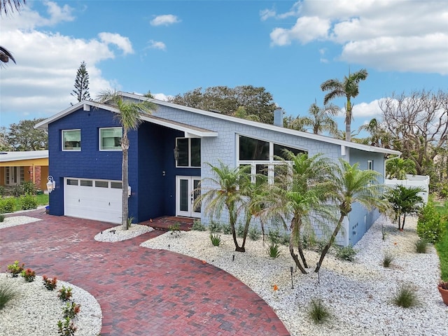 931 Gulf Blvd, Belleair Beach, FL 33786 - view of front of home with french doors, an attached garage, and decorative driveway