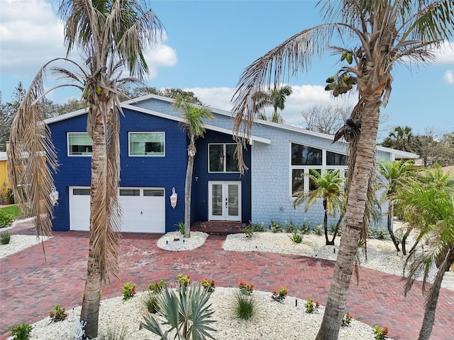 931 Gulf Blvd, Belleair Beach, FL 33786 - view of front of house featuring french doors, an attached garage, and decorative driveway