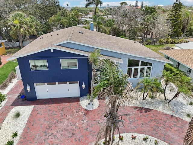 931 Gulf Blvd, Belleair Beach, FL 33786 - view of front of house featuring a garage, a shingled roof, and decorative driveway