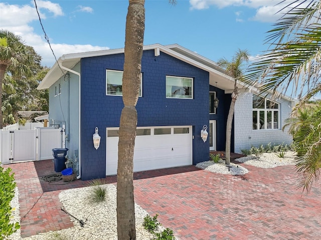 931 Gulf Blvd, Belleair Beach, FL 33786 - view of front of property featuring a gate, a garage, and decorative driveway