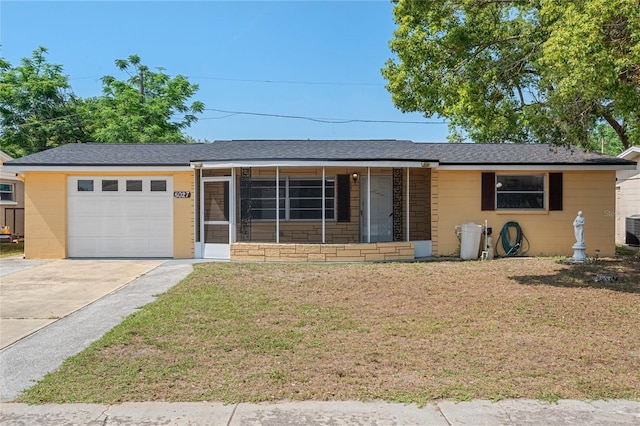 5027 Overton Dr, New Port Richey, FL 34652 - ranch-style home featuring an attached garage, a front lawn, and driveway