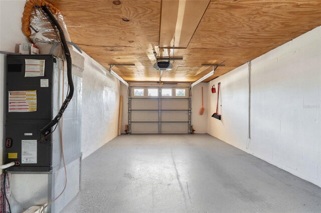 5027 Overton Dr, New Port Richey, FL 34652 - garage featuring a garage door opener and heating unit