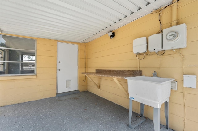 5027 Overton Dr, New Port Richey, FL 34652 - miscellaneous room with concrete block wall and speckled floor