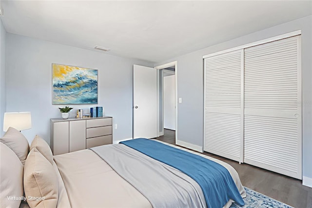5027 Overton Dr, New Port Richey, FL 34652 - bedroom featuring dark wood-type flooring and a closet