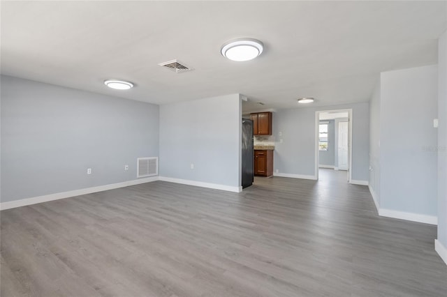 5027 Overton Dr, New Port Richey, FL 34652 - unfurnished living room featuring wood finished floors