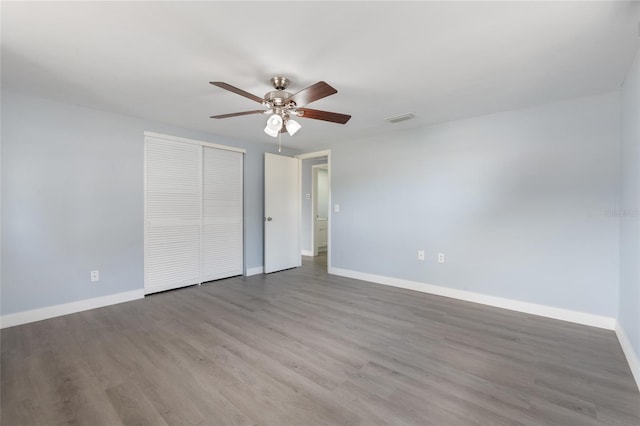 5027 Overton Dr, New Port Richey, FL 34652 - unfurnished bedroom with wood finished floors, a closet, and a ceiling fan
